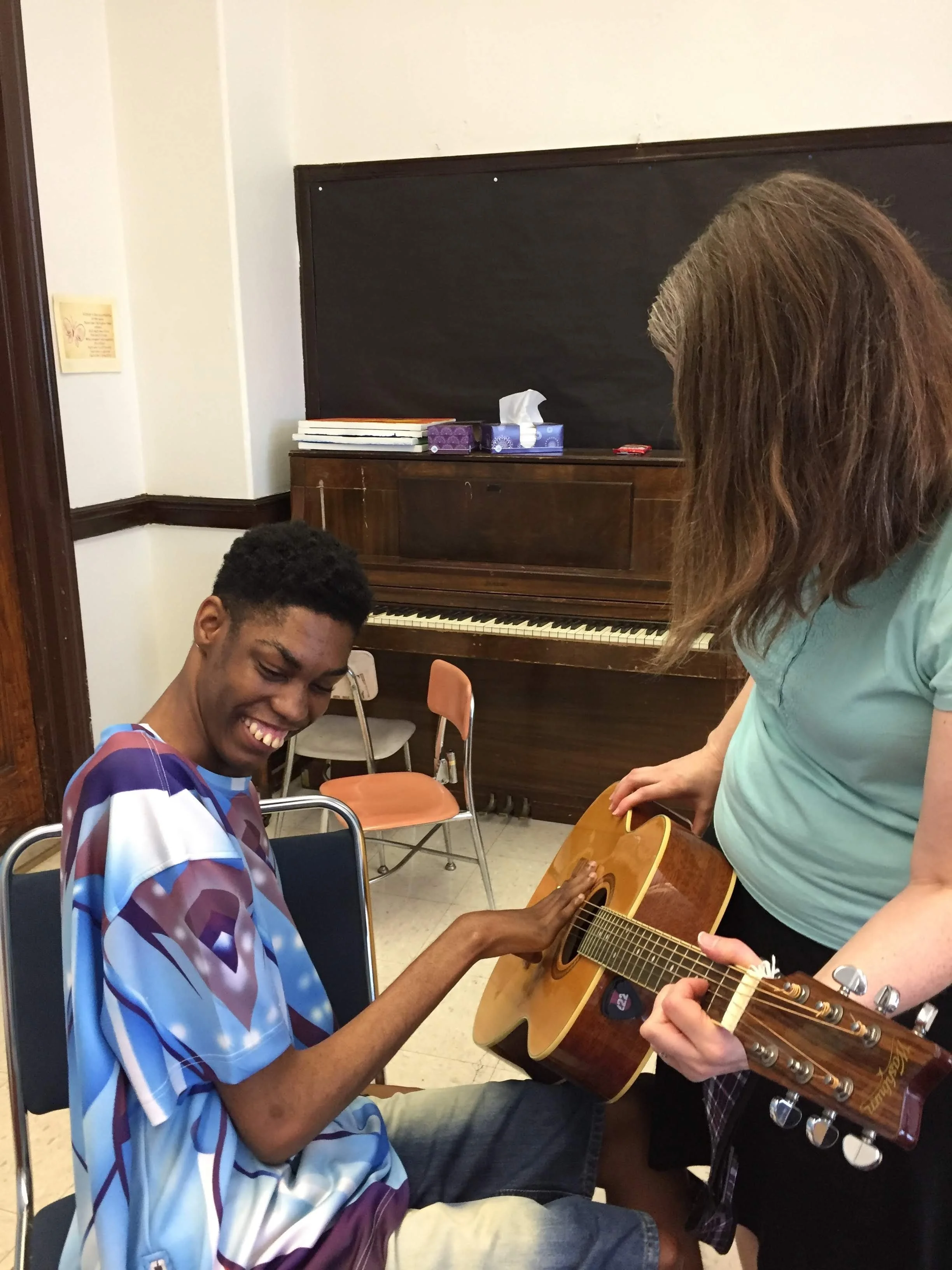 A student and music therapist at the keyboard