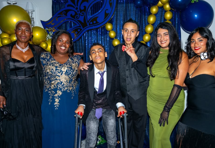 Students and staff pose together at prom