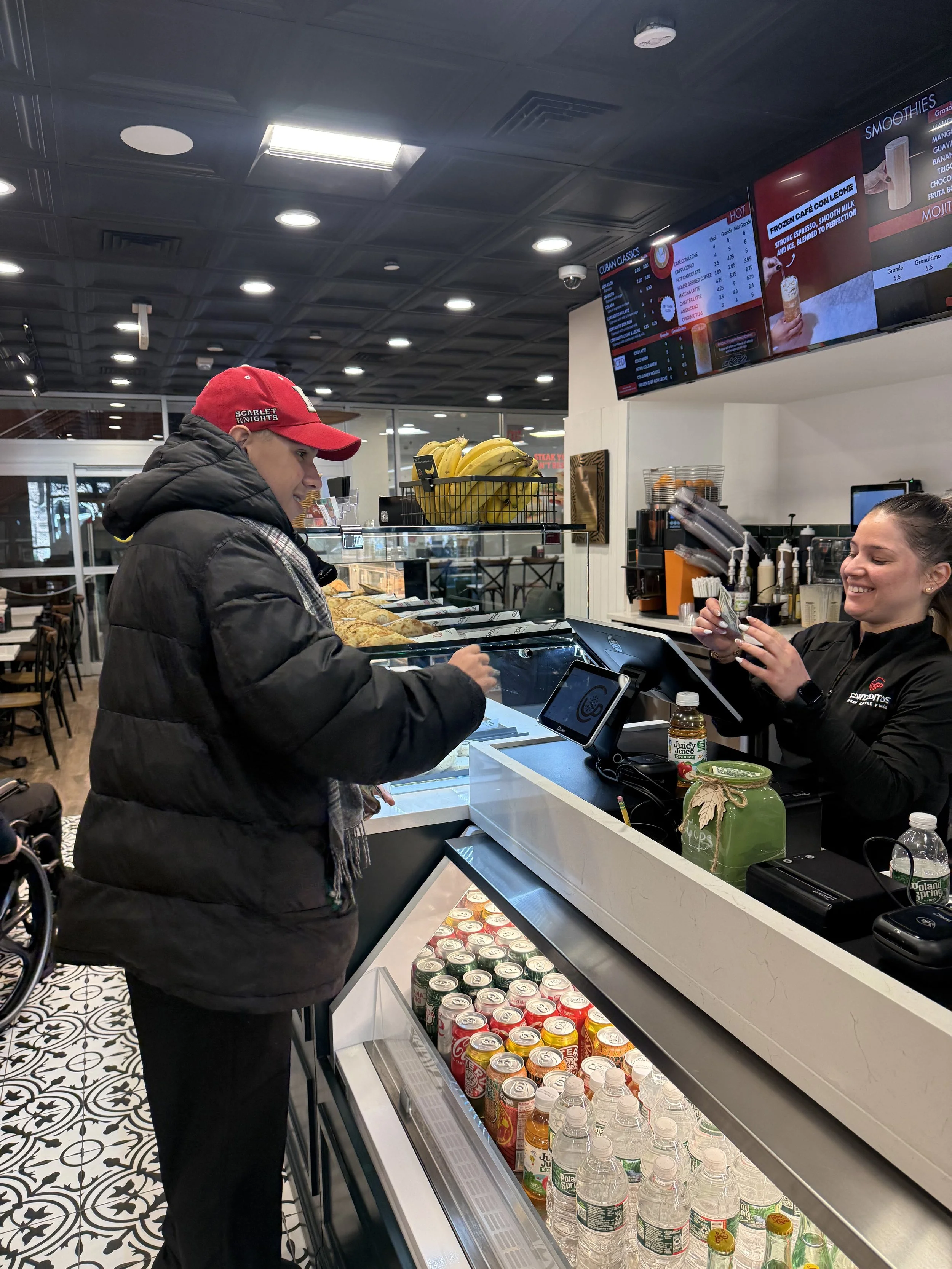A student orders at a store counter during community-based instruction