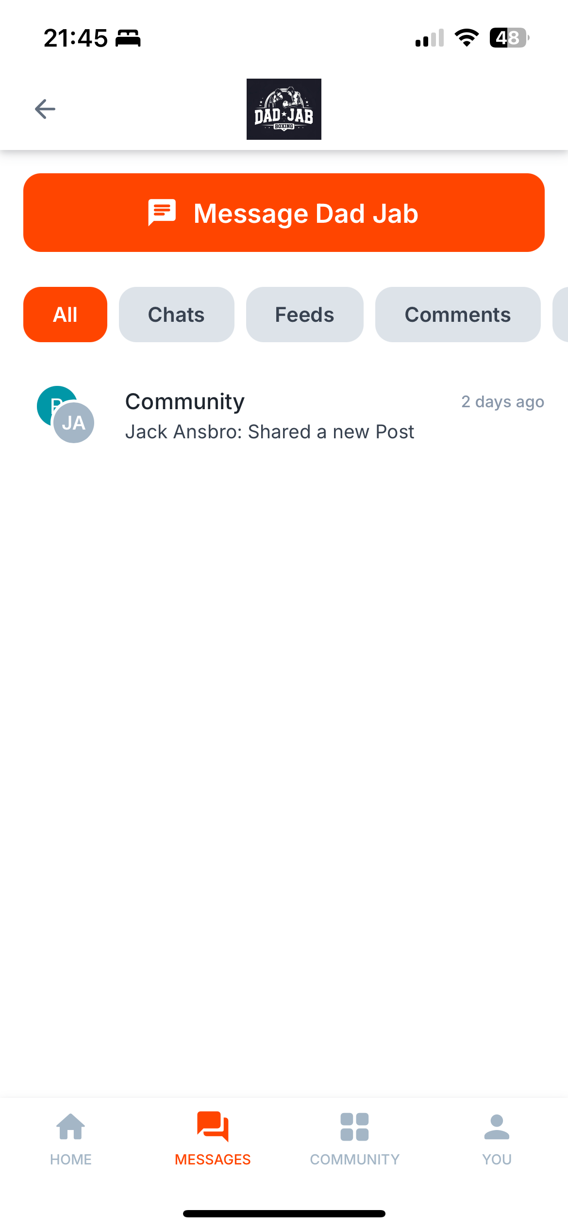 Mobile phone screen showing a messaging app with the profile name 'Dad JAB Boxing' and a message button to 'Message Dad Jab', with tabs labeled All, Chats, Feeds, Comments. There is a community post shared by Jack Ansbro.