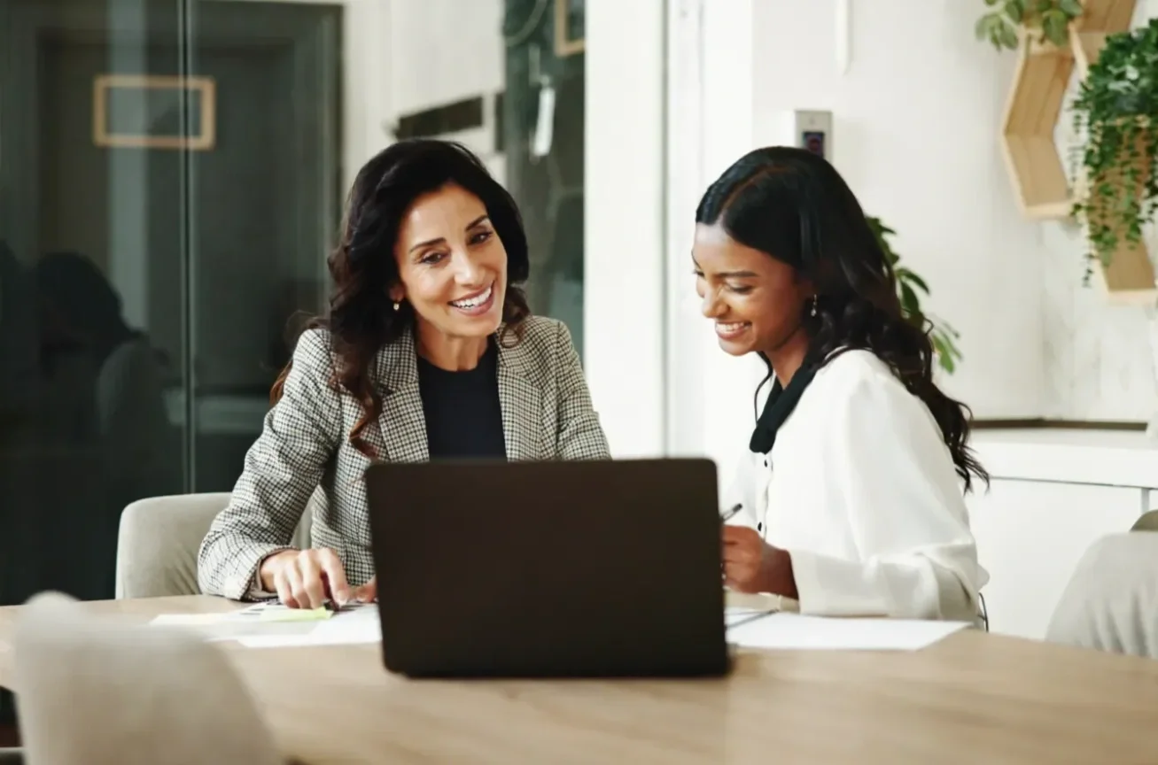 Employer and employee sitting in front of laptop computer