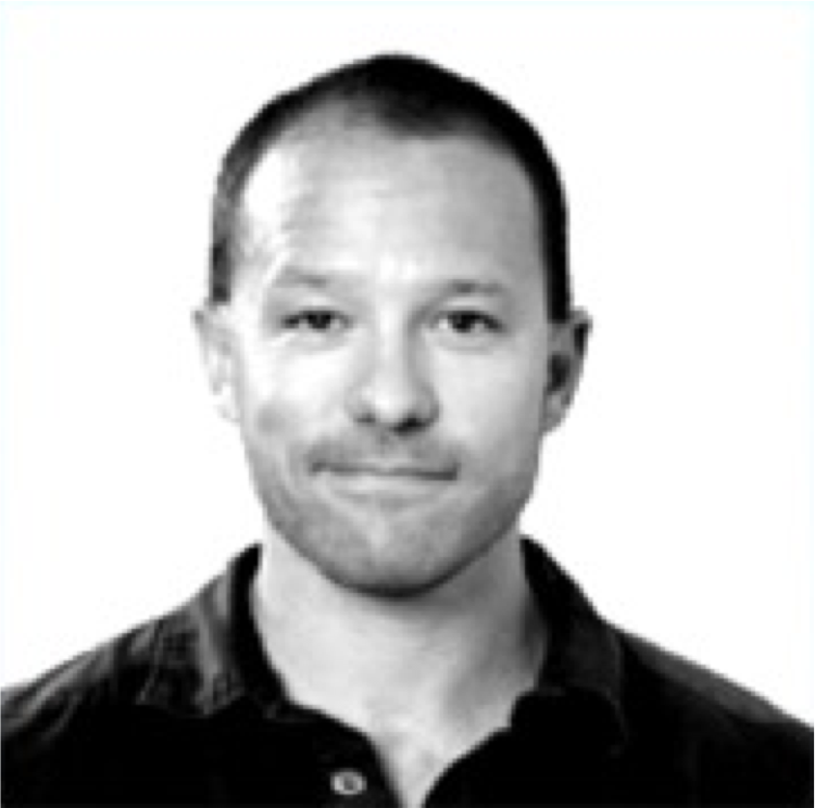 Black and white portrait of a man with short hair, wearing a collared shirt, facing forward against a plain background.