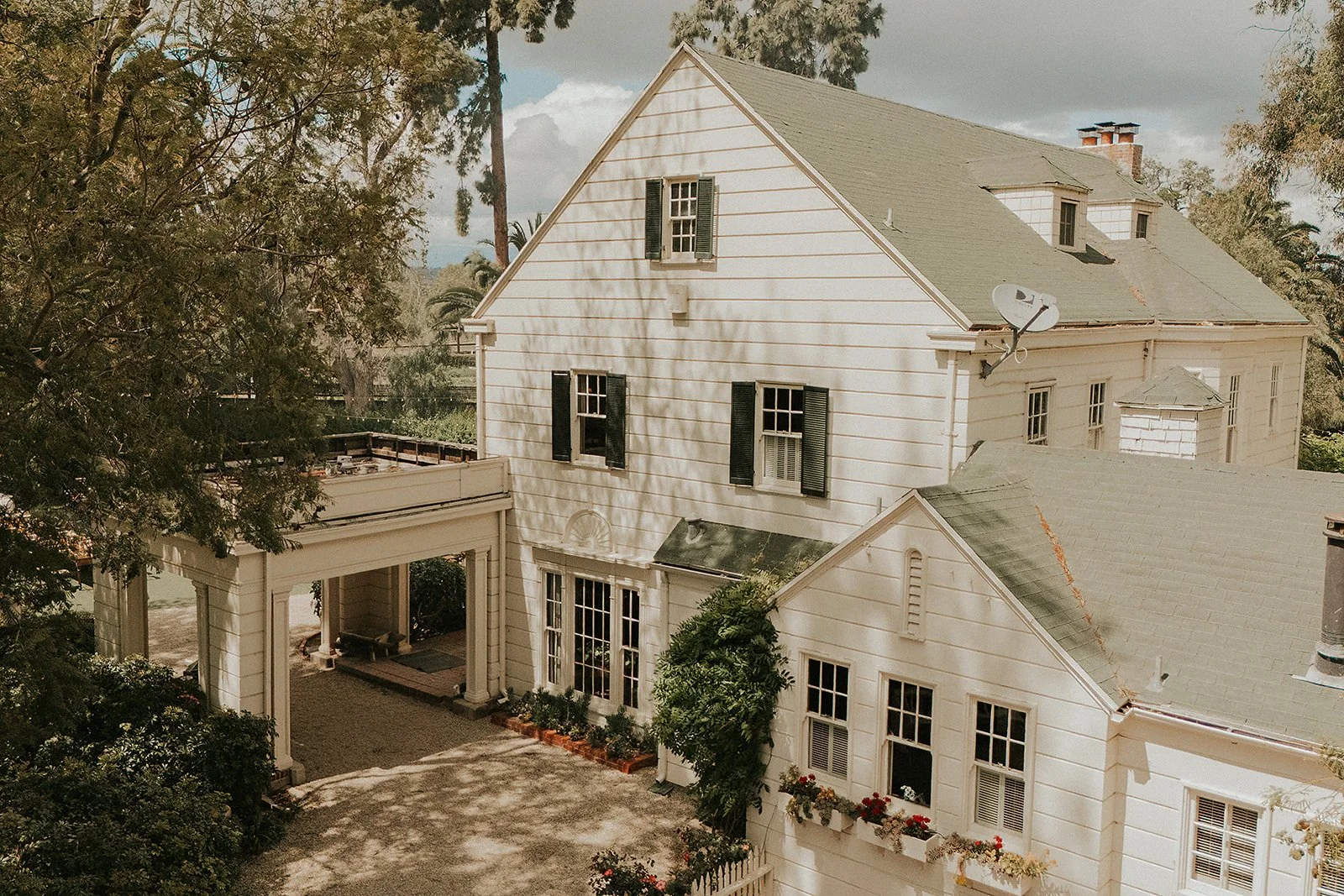 View of the Home Ranch with cart port and greenery.