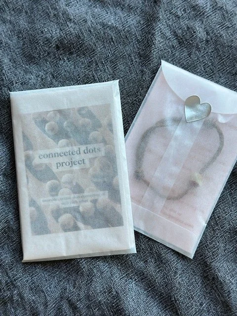 gift packaging with zine and dot bracelet
