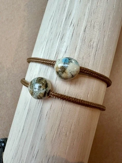 sand and blue dots on copper paracord