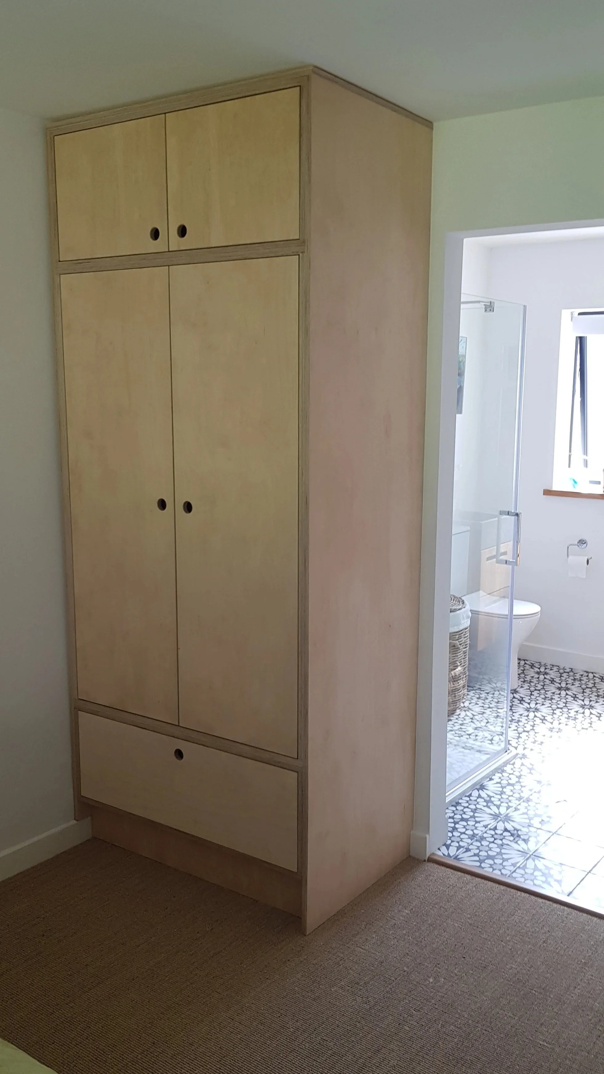 Custom birch plywood wardrobe with a modern minimalist design, handcrafted in North Norfolk.
