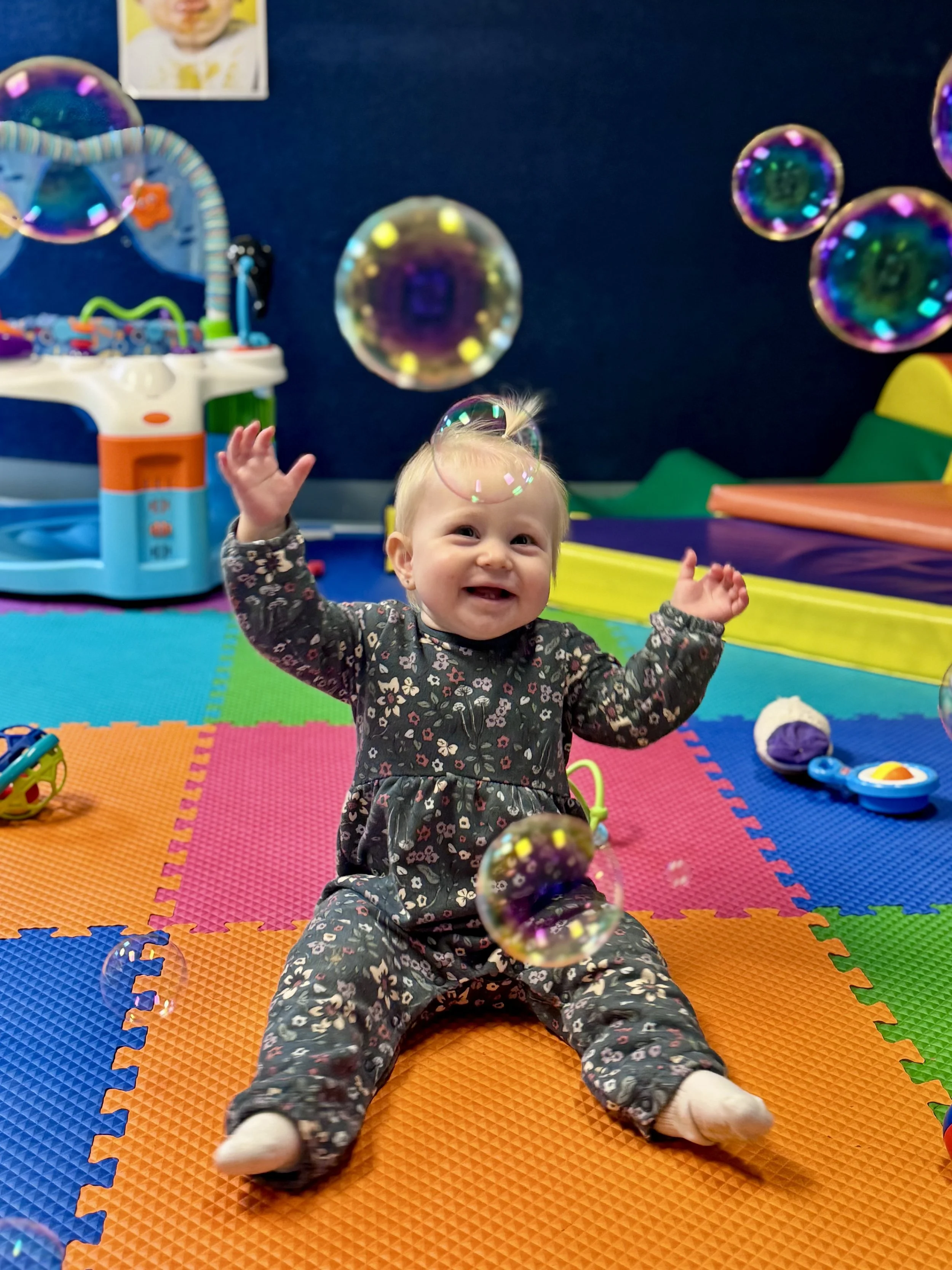 Baby playing with bubbles in preschool