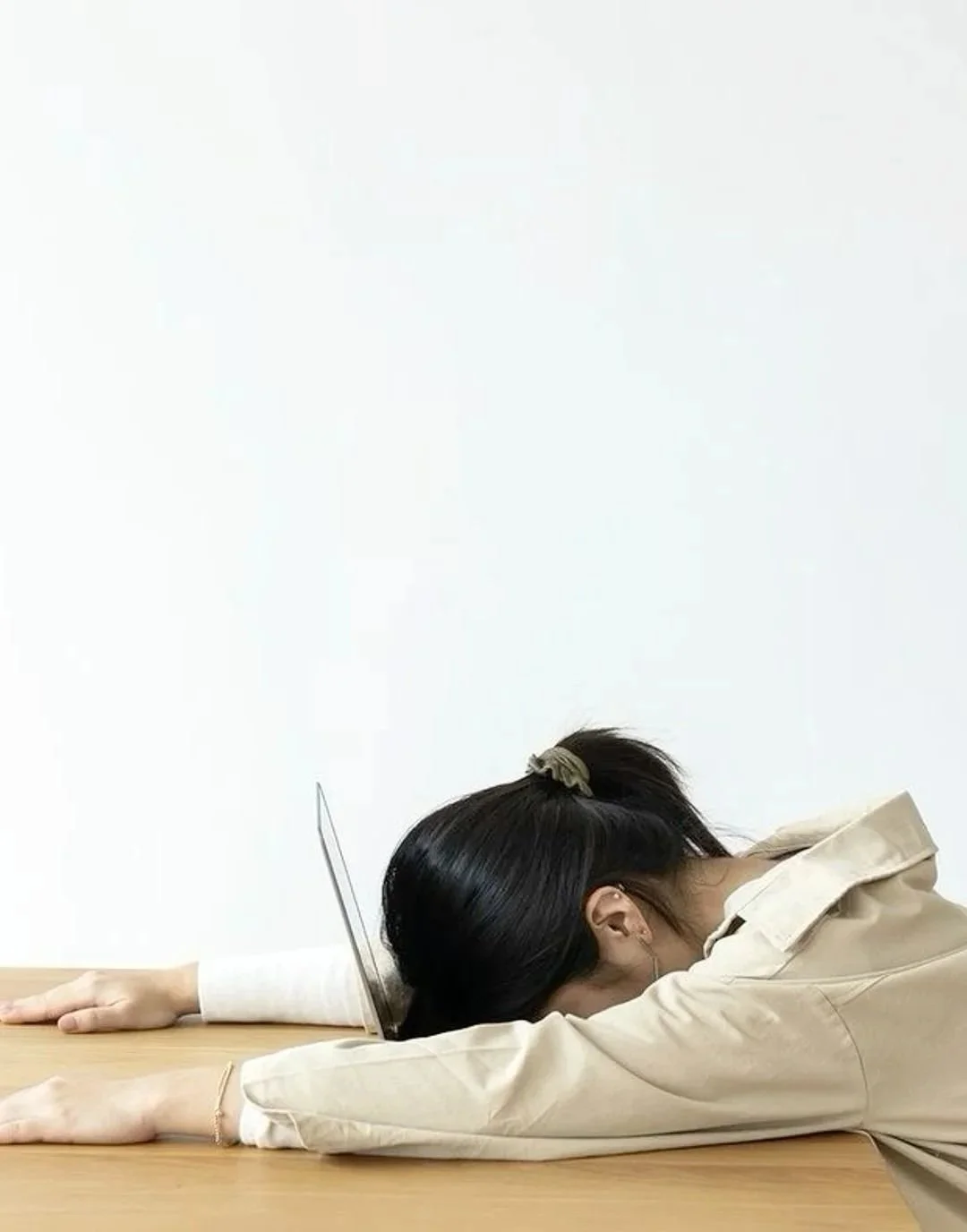 aapi-woman-stressed-with-head-on-laptop