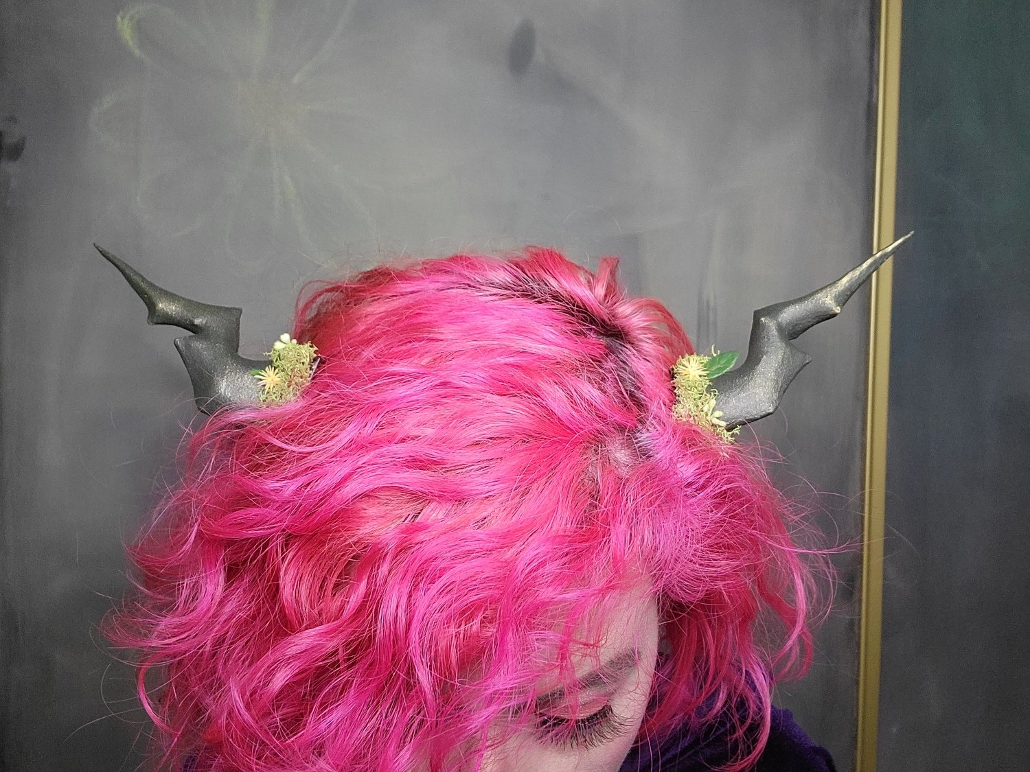 small, clip-in, dragon-style, jagged greenish-brown horns with bright greenish-yellow moss around the base, and tiny flowers and leaves appearing to grow from the moss