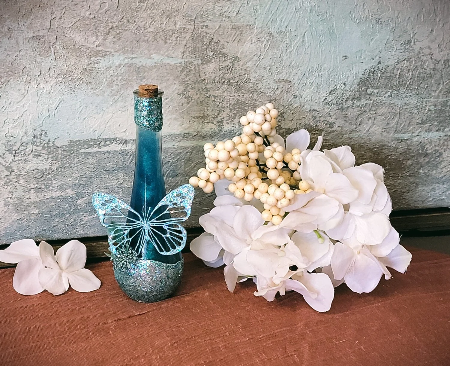 A color-shifting potion bottle with a blue butterfly, and shimmery blue liguid moving inside of it. 