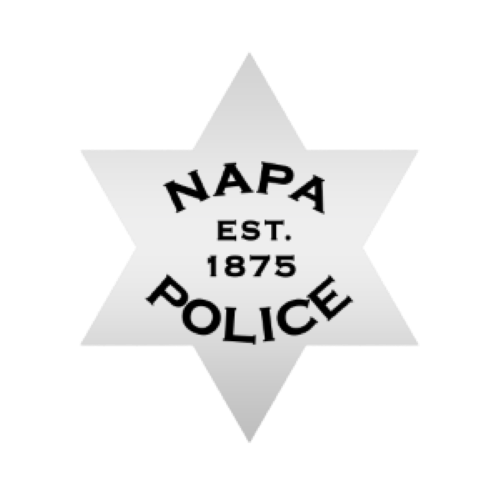 Napa Police badge with the text 'NAPA POLICE EST. 1875' in black on a white star-shaped background.