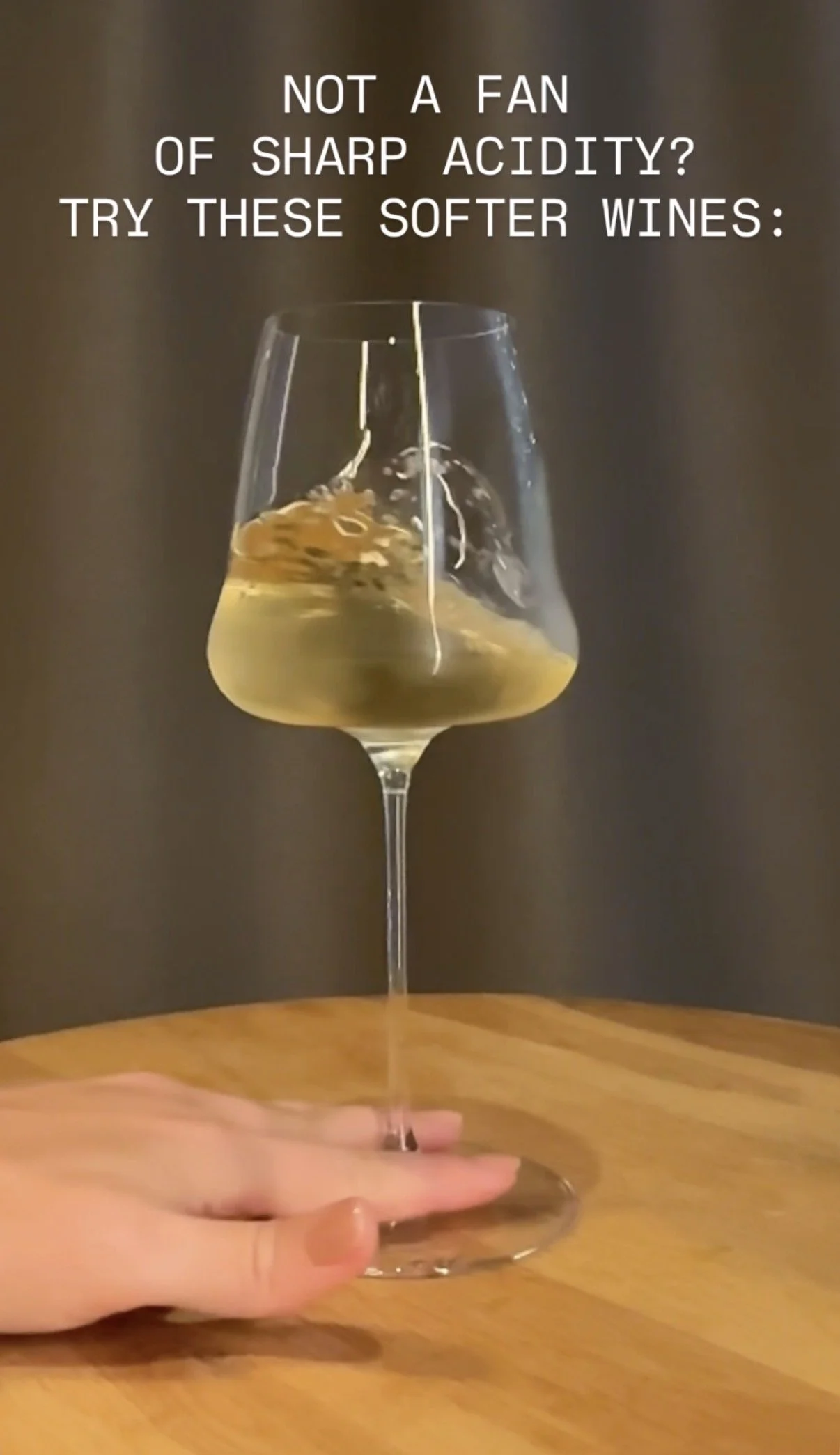 Text overlay on a wine glass with a splash of white wine: "Not a fan of sharp acidity? Try these softer wines."