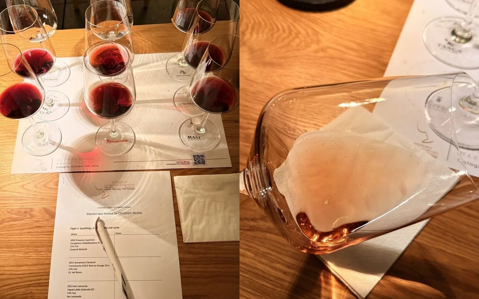 Tasting mat with nine glasses of red wine for the first flight at the Istituto Grandi Marchi masterclass, next to a glass holding the foamy remains of a spat-out wine
