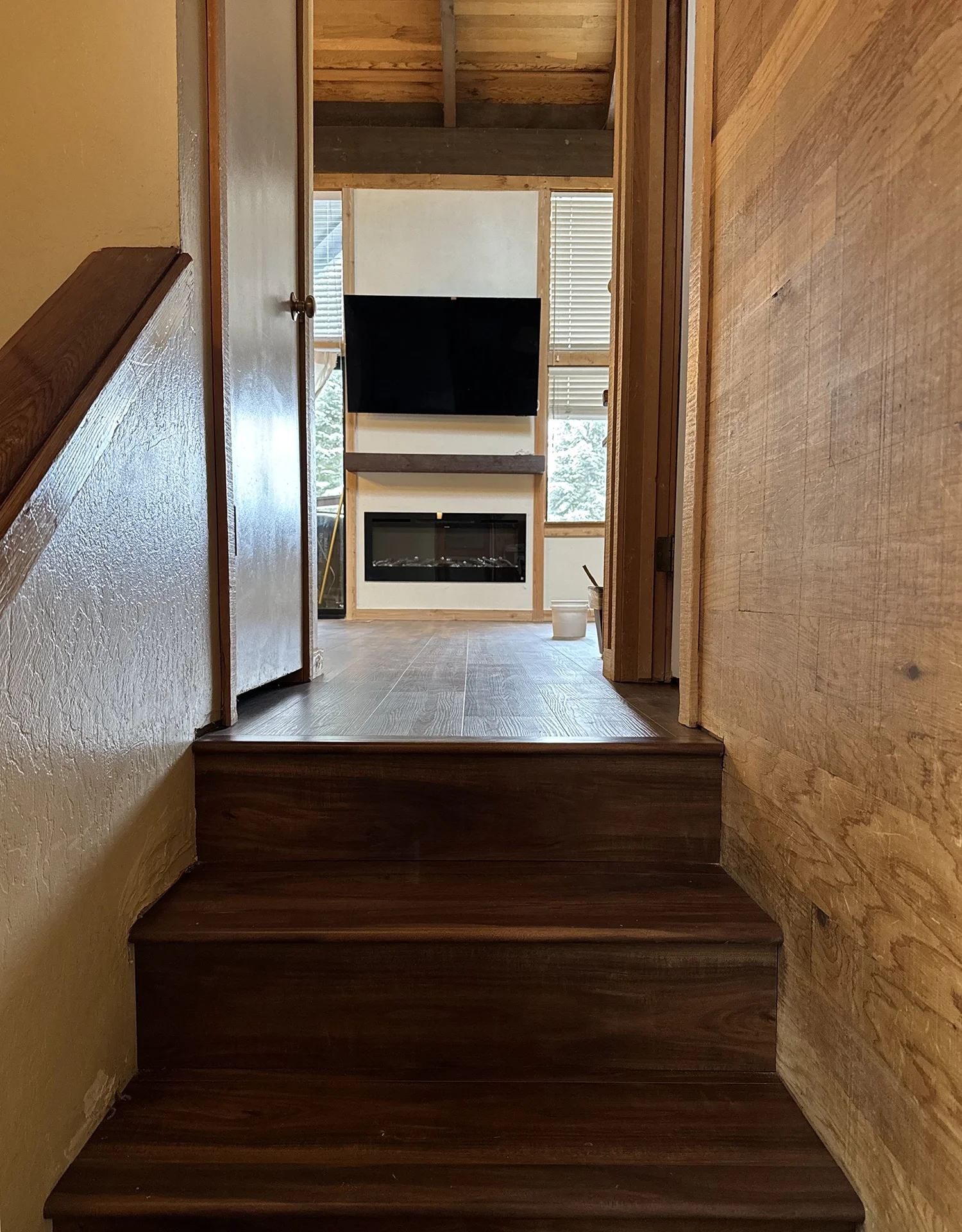 view from hallway into living room of fireplace insert and flat screen tv