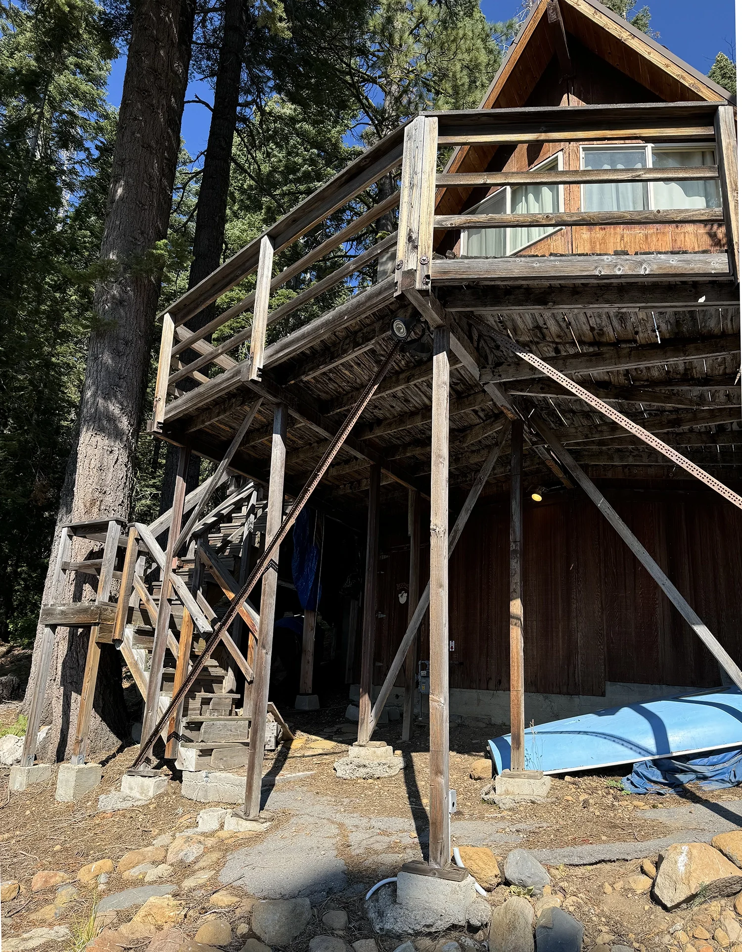 old unstable deck with rotting wood and stairs 