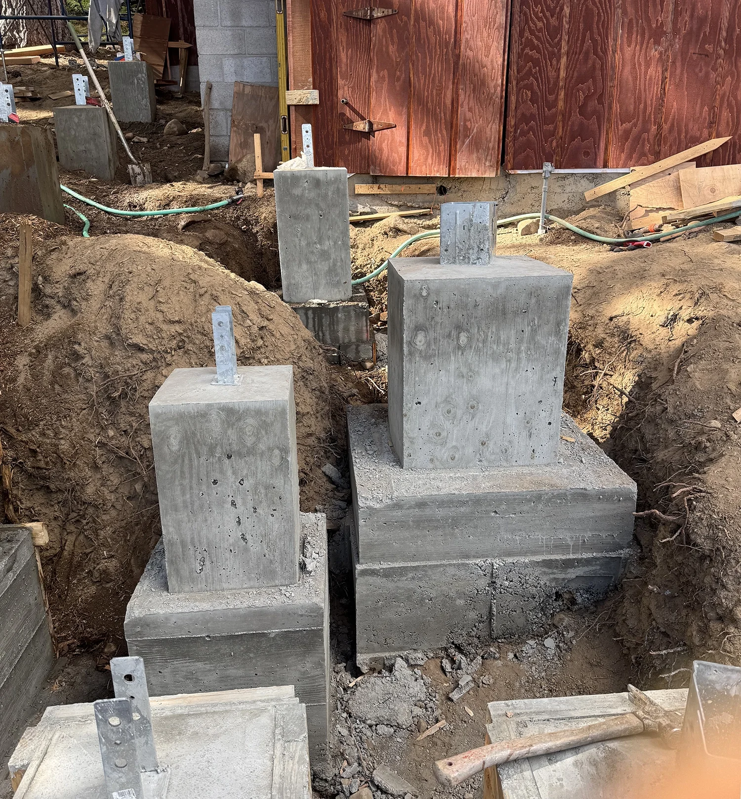 excavated ground with concrete footings for large deck