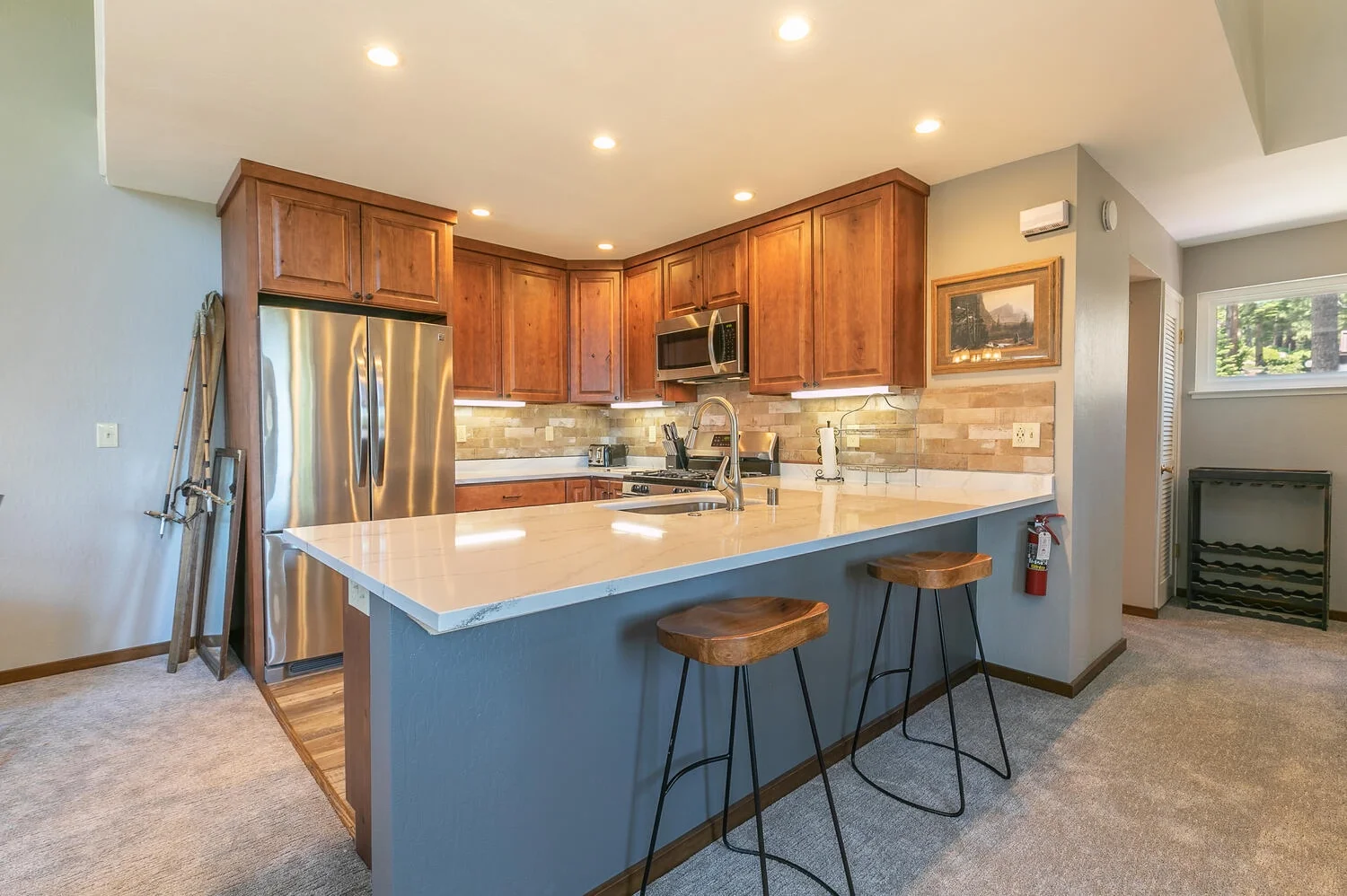 rustic barstools at white marble kitchen bar