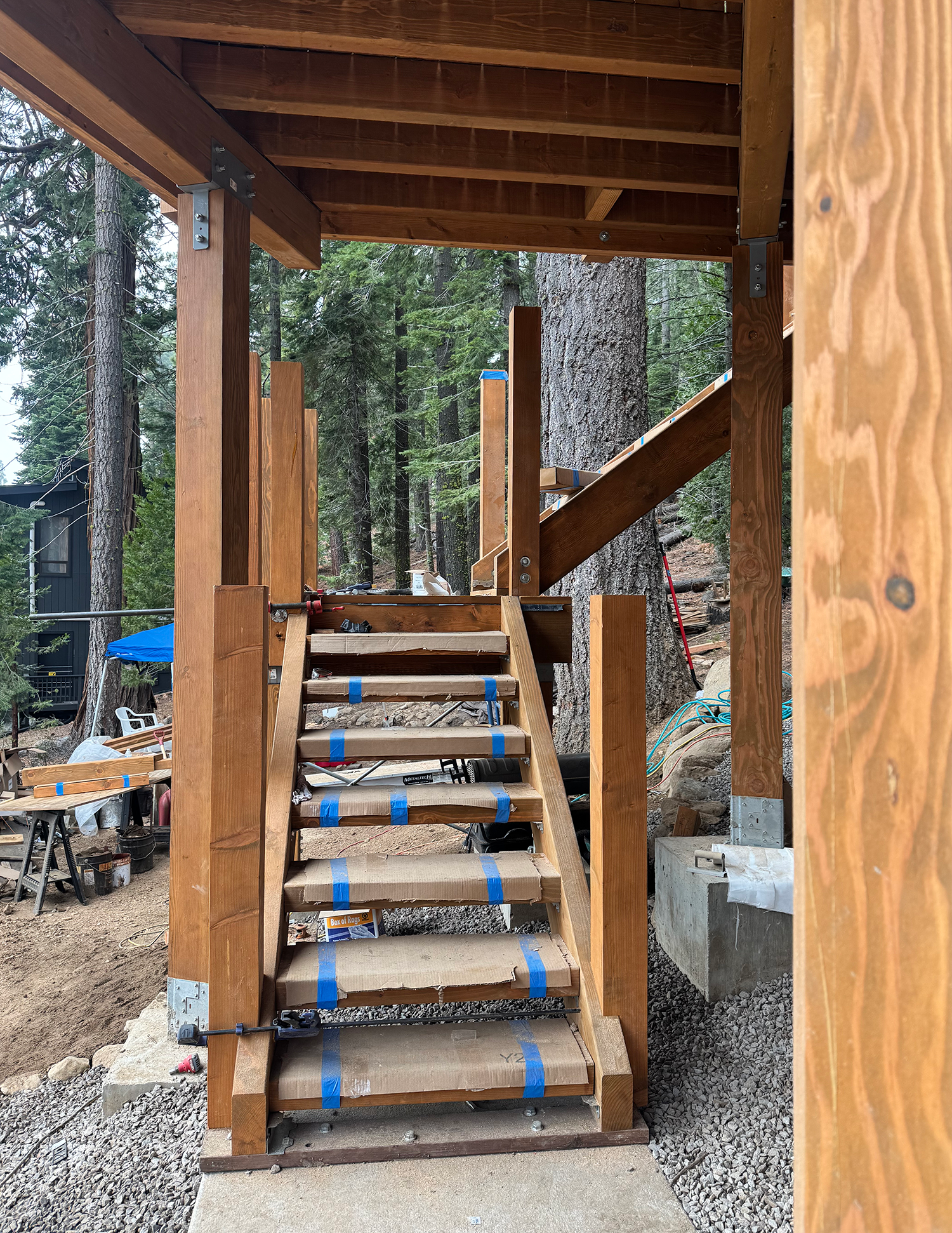 new plank stairs going up to newly constructed deck