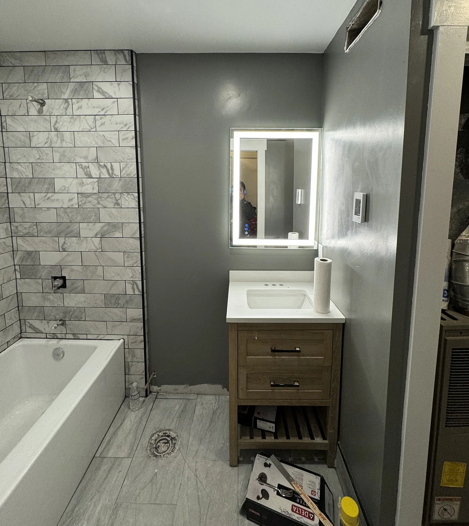 bathroom with grey wood floor and dark grey walls