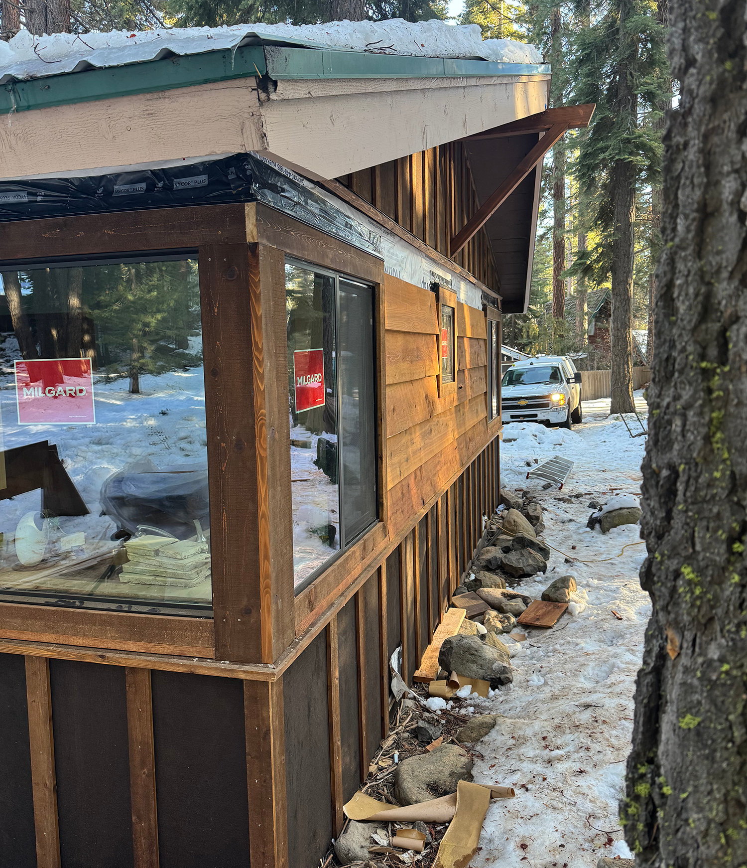 wood siding and new windows still with stickers on them