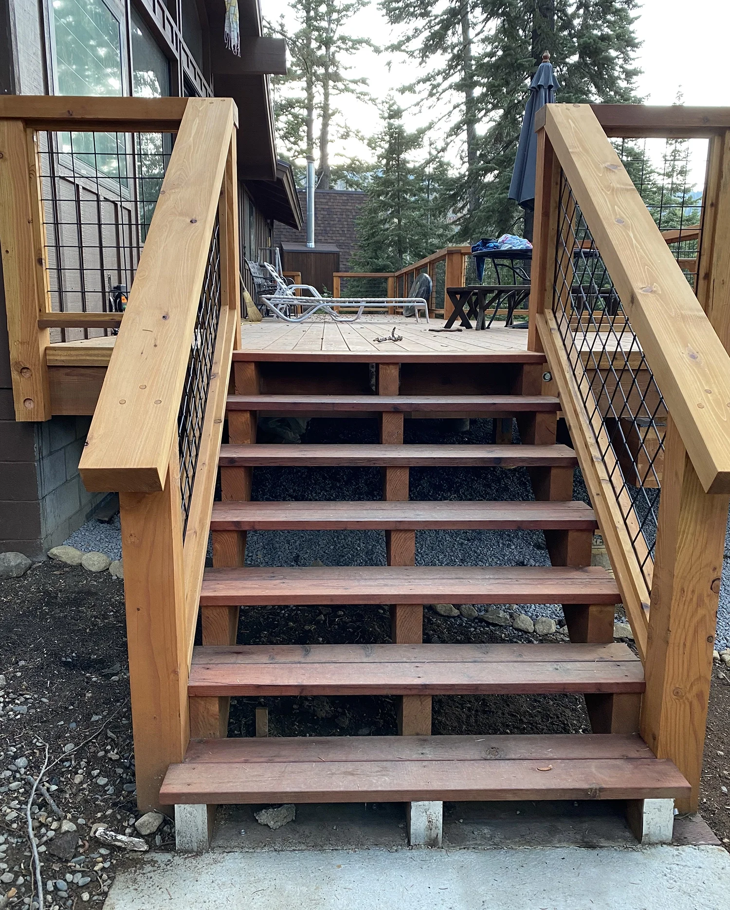stairs with hogwire railings on deck