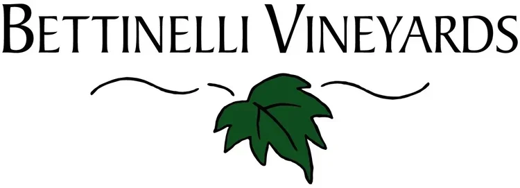 Logo of Bettinelli Vineyards with text and a green grape leaf