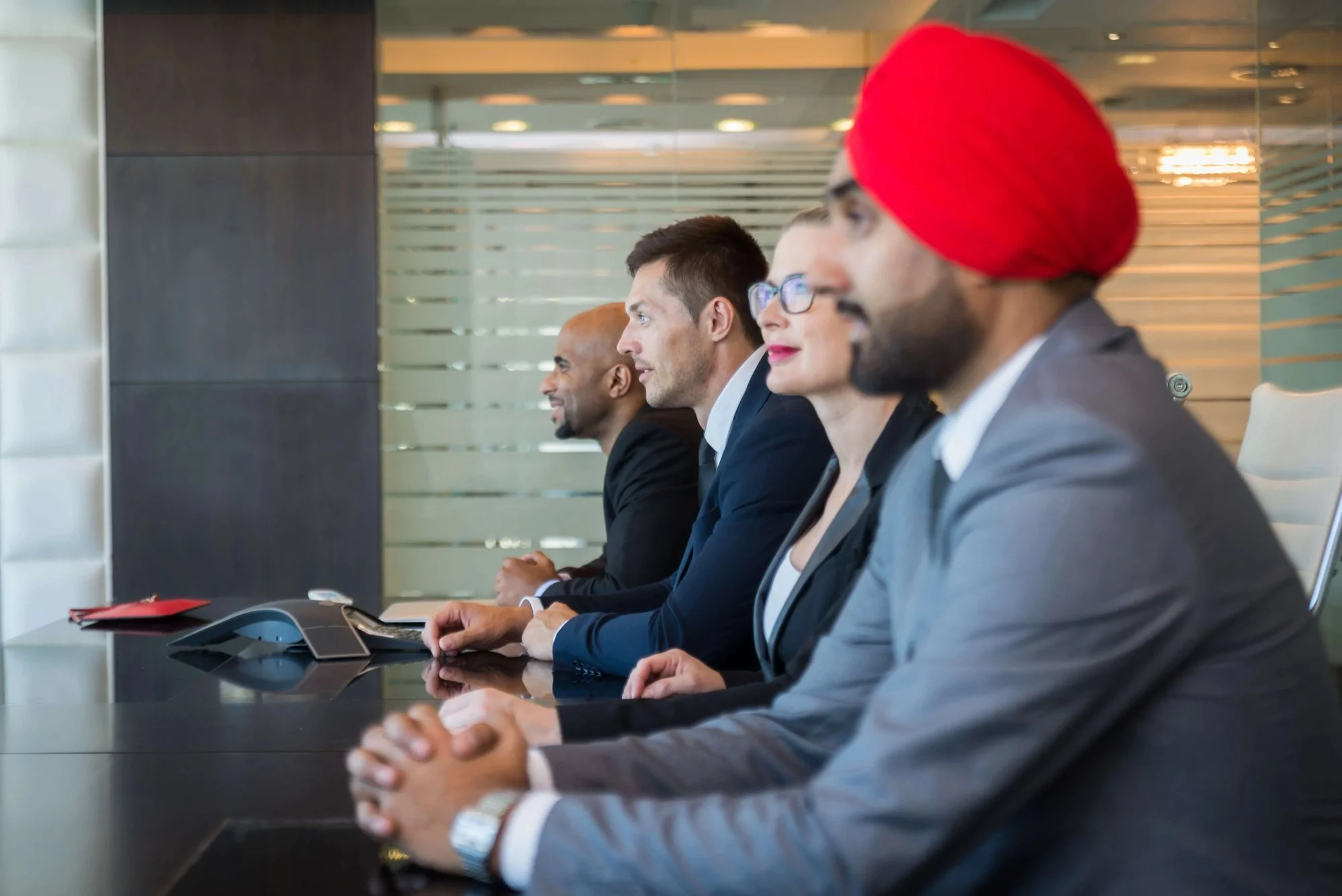 A diverse management team collaborating around a conference table.