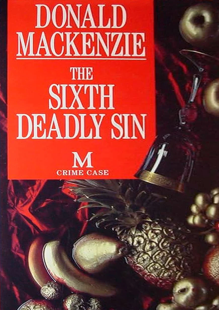 Close-up of a book titled "The Sixth Deadly Sin" by Donald Mackenzie, with a decorative background including a pineapple, apples, a bottle of wine, and other fruit.