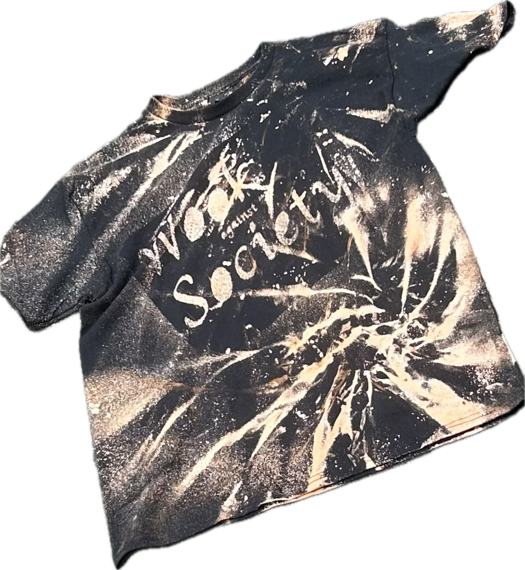 Black T-shirt featuring white text and graphic design. The shirt has a tie-dye or splattered paint pattern and features the words 'The Sonic Youth' in stylized font.