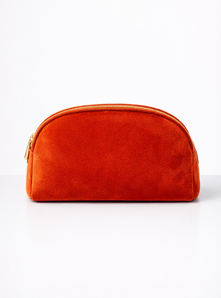 Orange velvet zippered pouch against a white background.