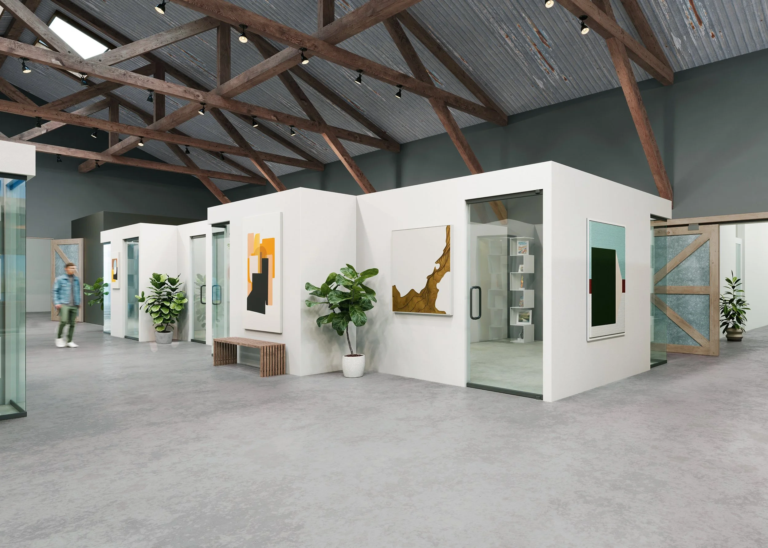 Interior view of an art gallery with white walls showcasing artwork, potted plants, and a wooden bench. The space has a high ceiling with exposed wooden beams and spotlights.