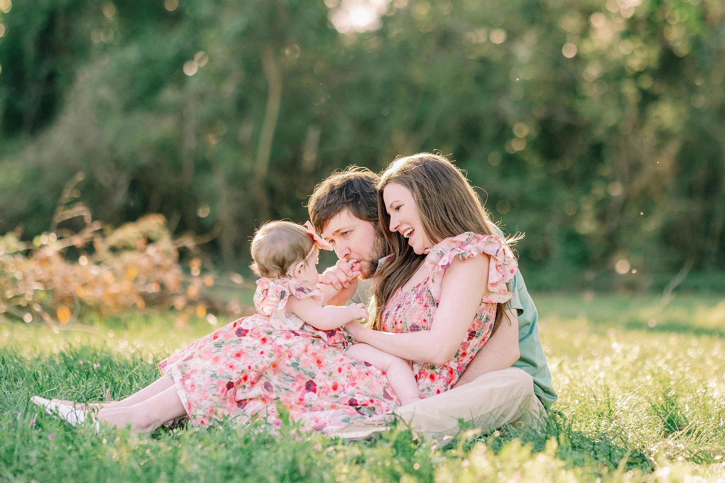 Family sitting together outdoors in warm natural light, representing the inspiration behind Saylor & Co.