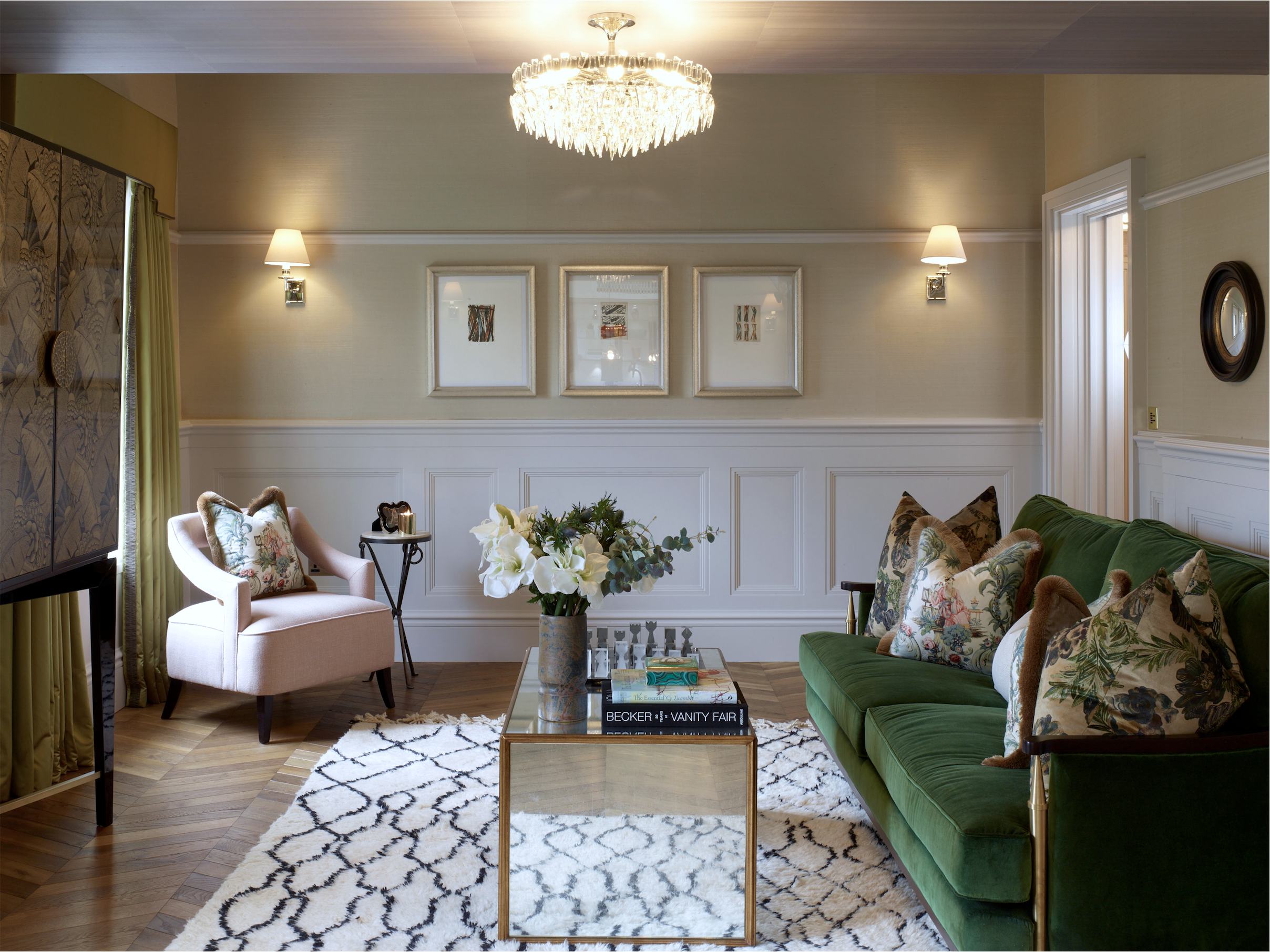 Studio L London sitting room with green sofa, framed art and layered soft furnishings