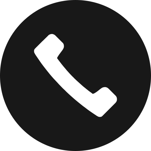Icon of a white telephone receiver on a black circular background.