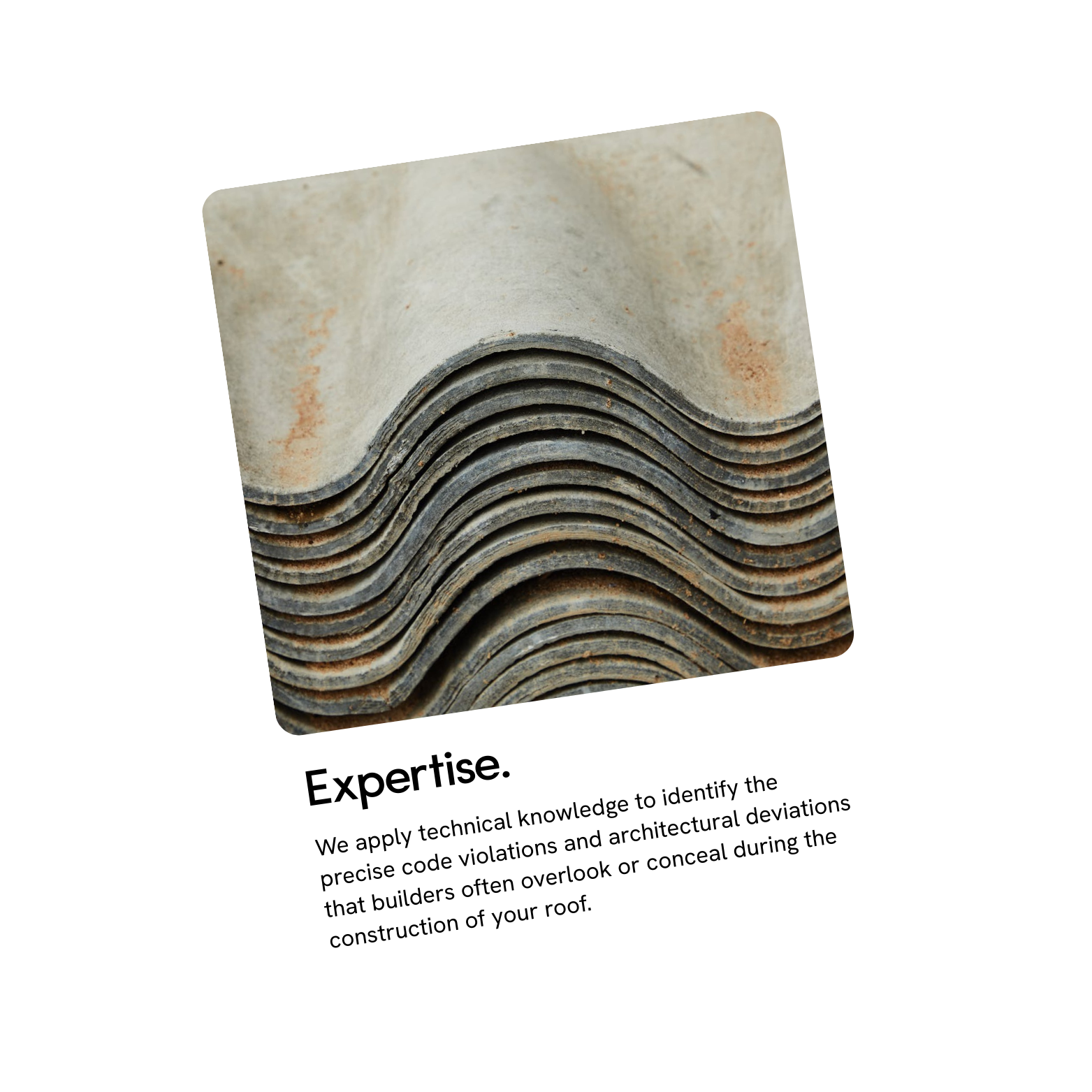 Close-up view of multiple gray roof tiles stacked together with some rust spots.