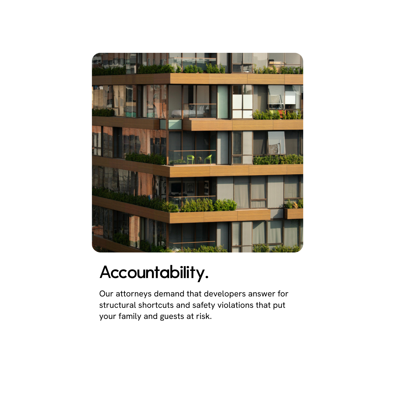 Close-up of a building with multiple balconies decorated with plants, chairs, and large glass windows.