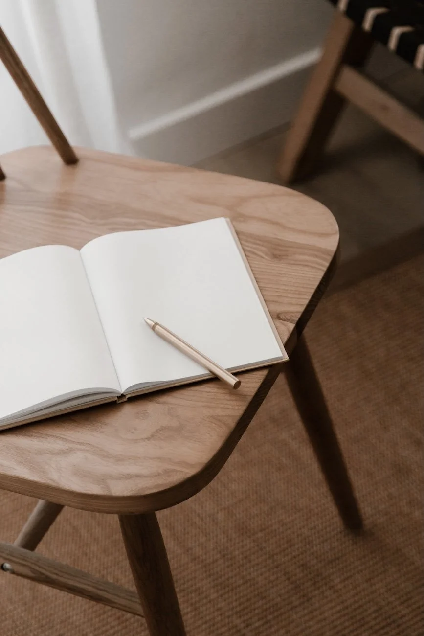 open blank notebook on wooden chair