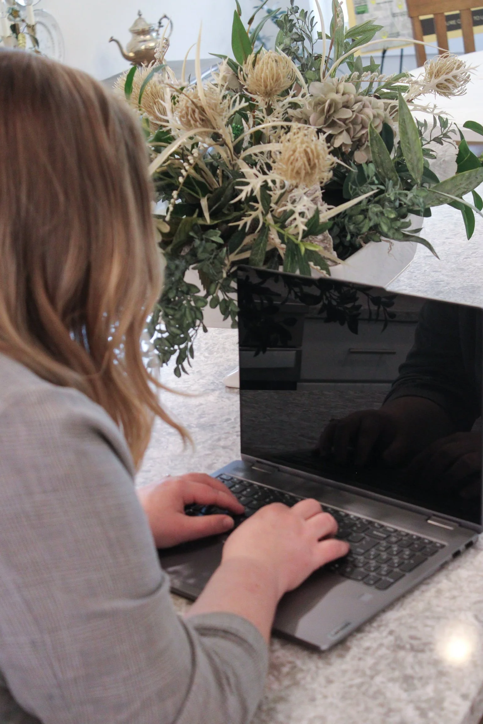 bookkeeper for creatives typing on laptop