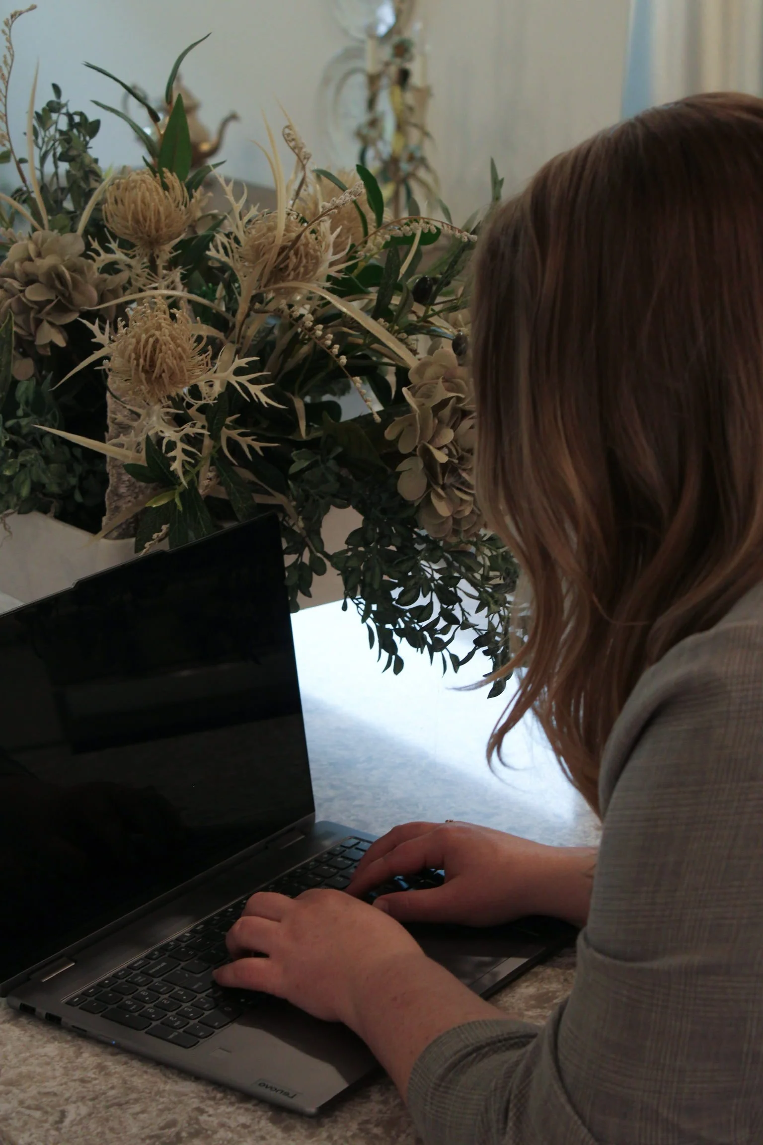 jessica of designed ledgers bookkeeping typing on laptop