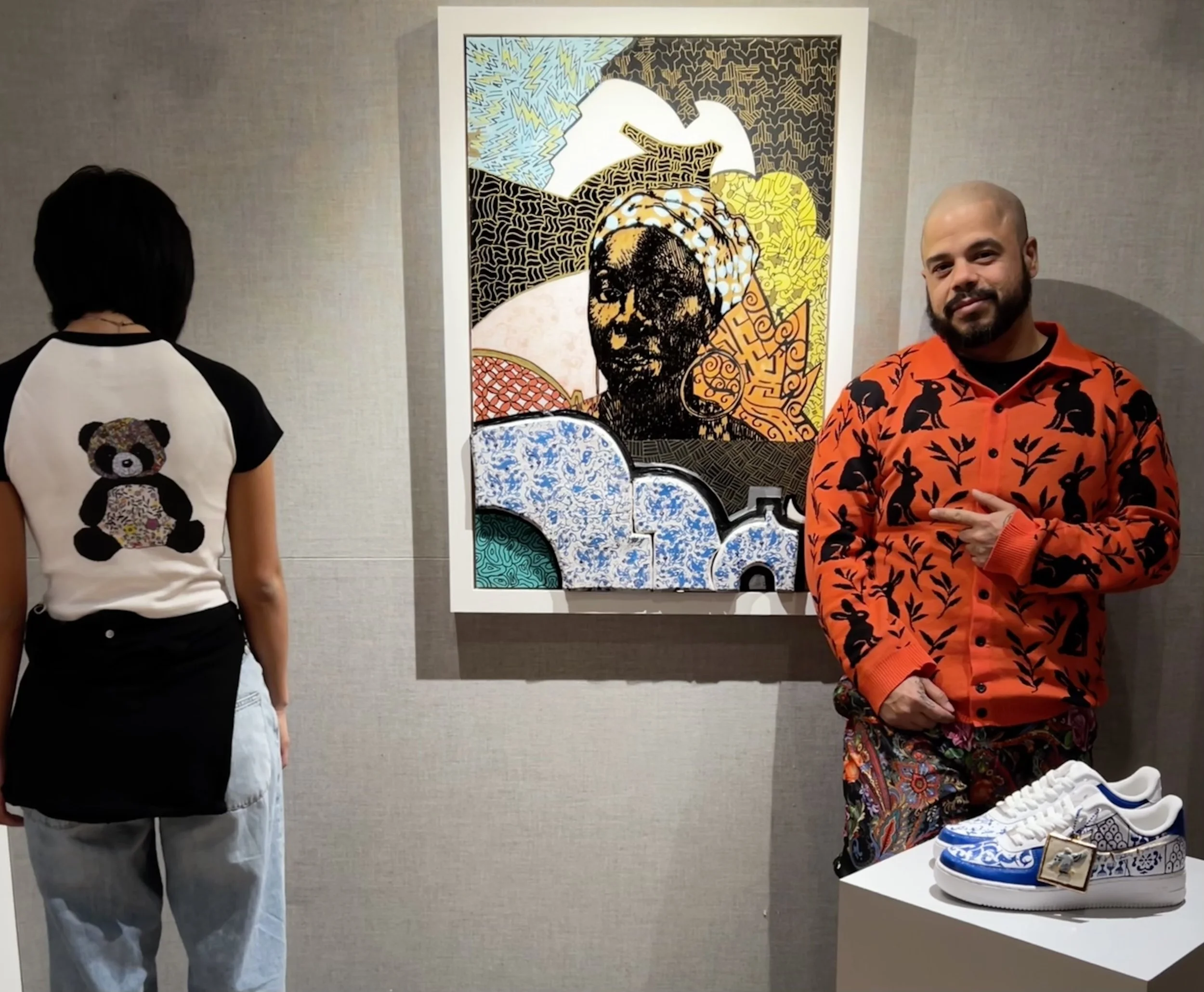 Roberto and intern wearing RL designed merch in pop-up shop