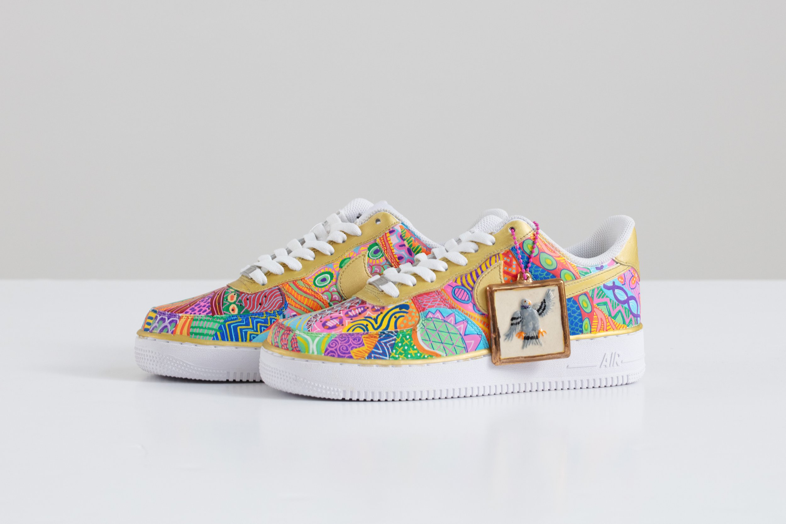 Roberto Lugo: Fooji. 2024. Pair of Air Force 1s with Air Pigeon Tag.