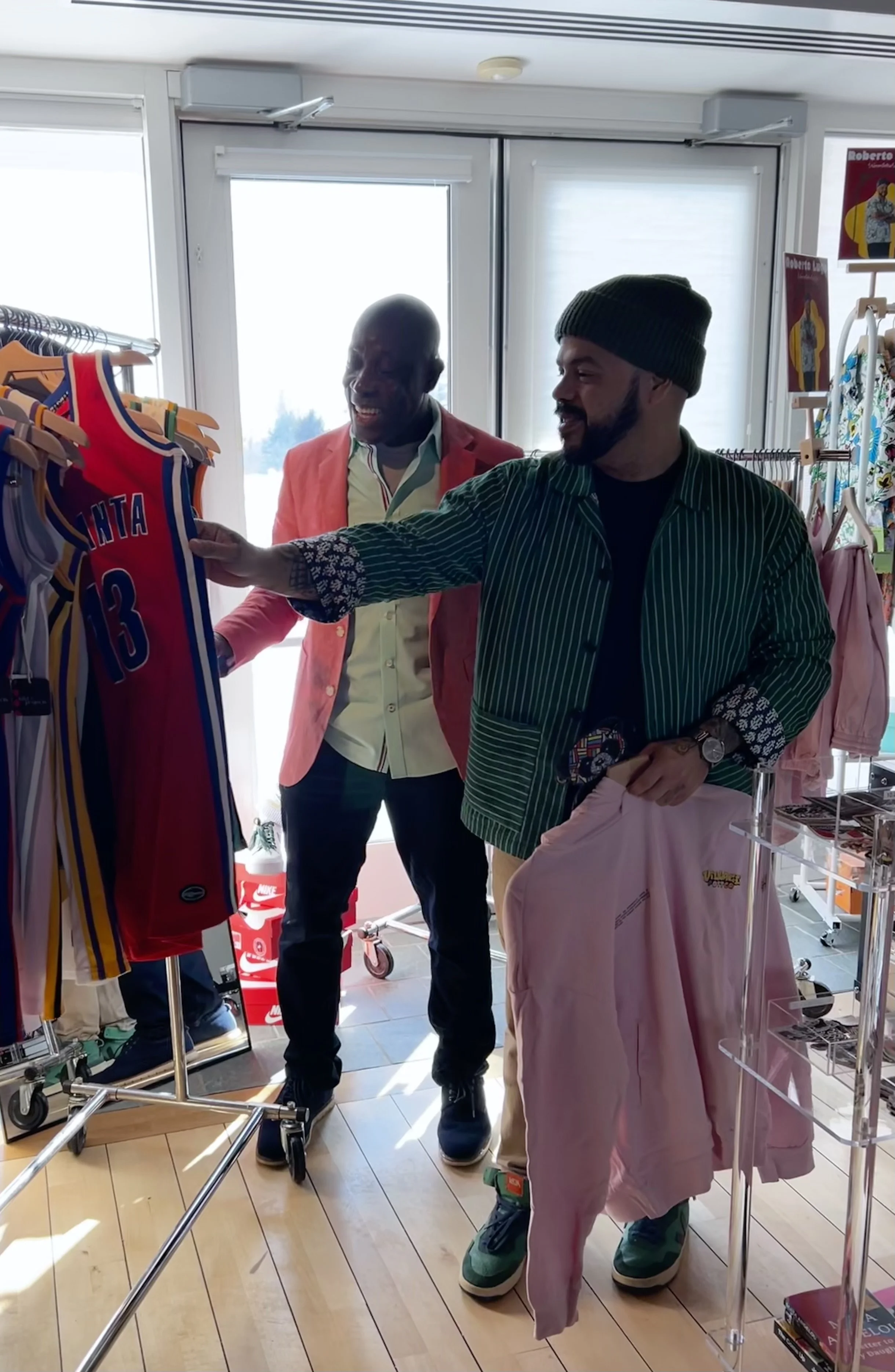 Roberto Lugo with his merch designs with designer Delroy Allen