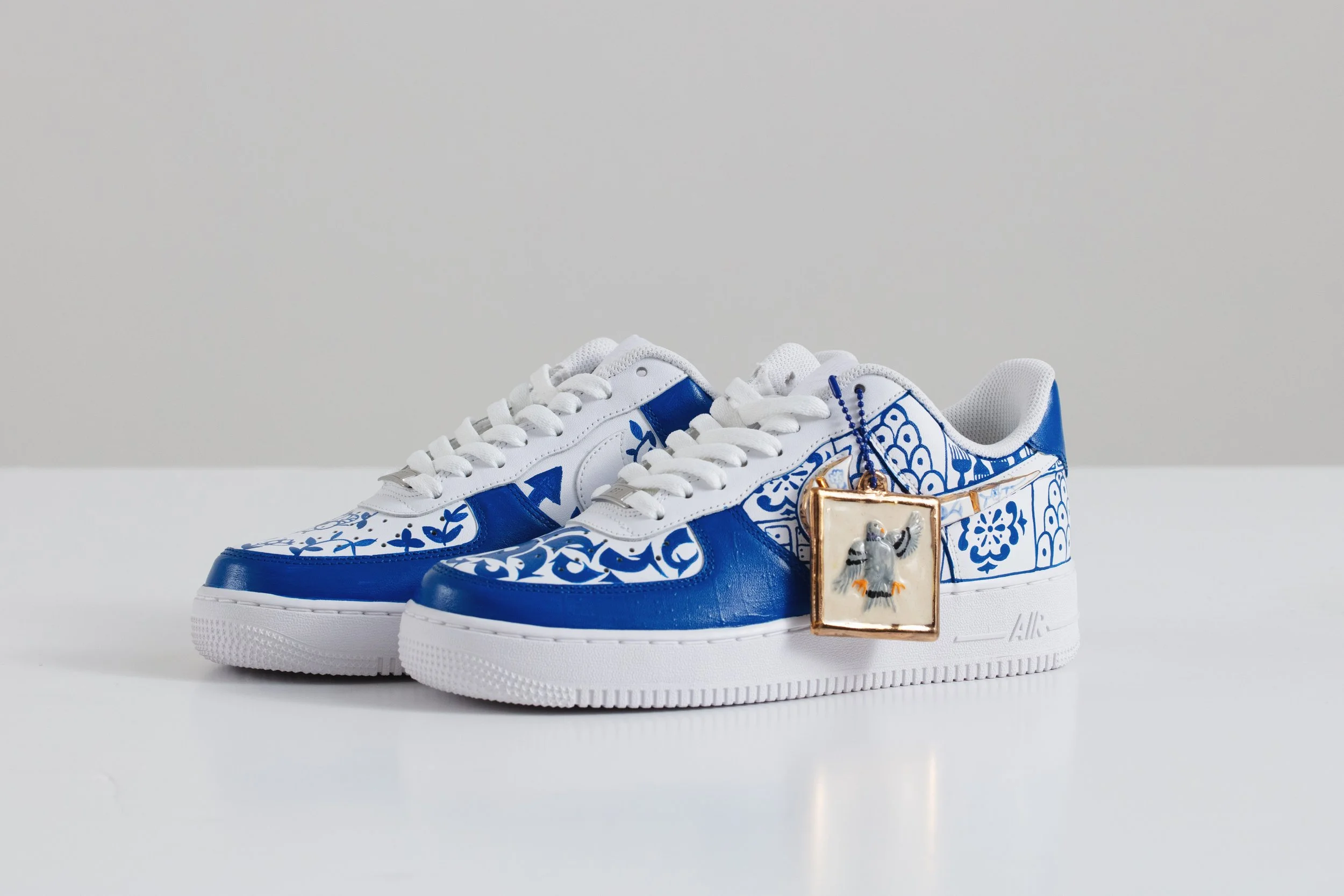 Roberto Lugo: Kintsugi. 2024. Pair of Air Force 1s with Air Pigeon Tag.