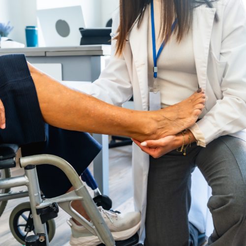Healthcare professional examining an elderly patient's arm in a medical office.