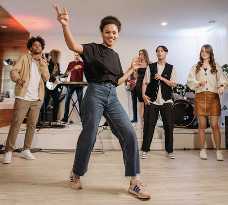 A young woman dancing and smiling while having fun and making friends at OklaMOTION Dance Studio in Henryetta, OK.