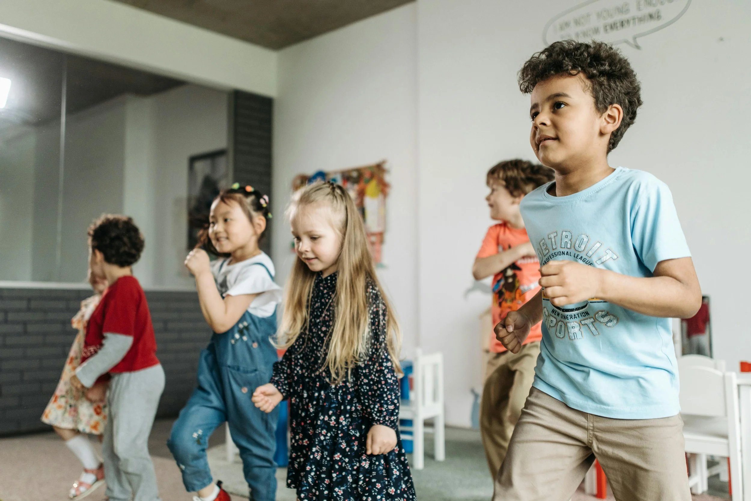 Children dancing and having fun in a dance studio.