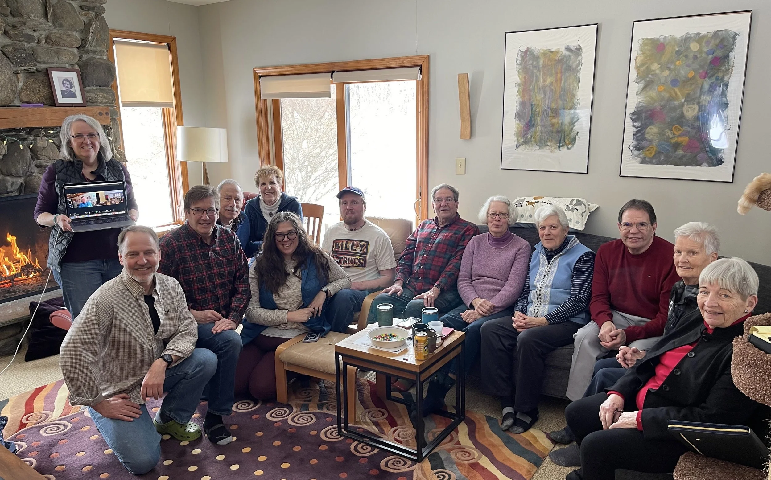 Fourteen Calvary and St. James vestry members relaxing at a joint vestry meeting at Calvary Senior Warden Jack Manning’s living room. A fire burns in the fireplace.