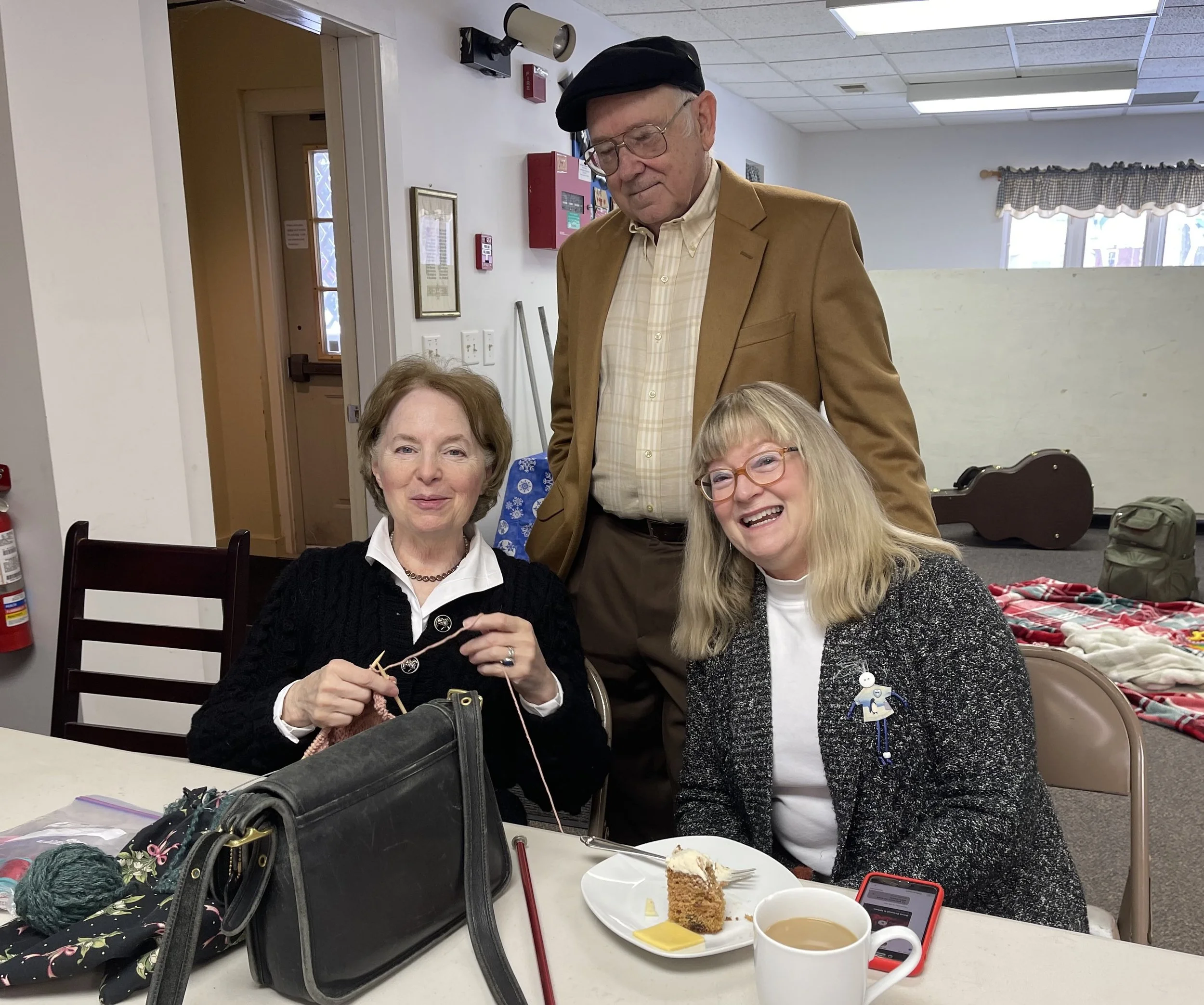 Three young women and one boy dressed in yellows and whites. The women are wearing dresses and the boy is dressed in a shirt and pants.