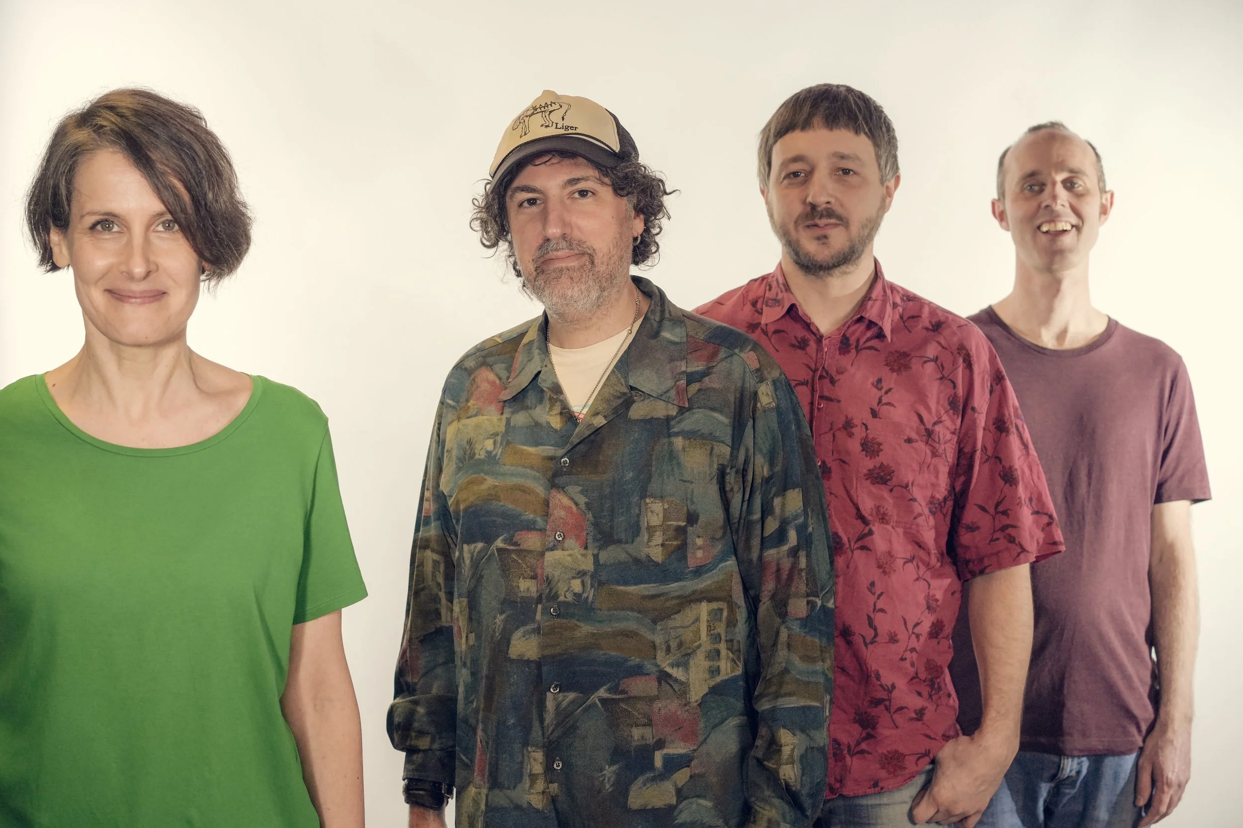 Four people standing side by side against a plain white background.