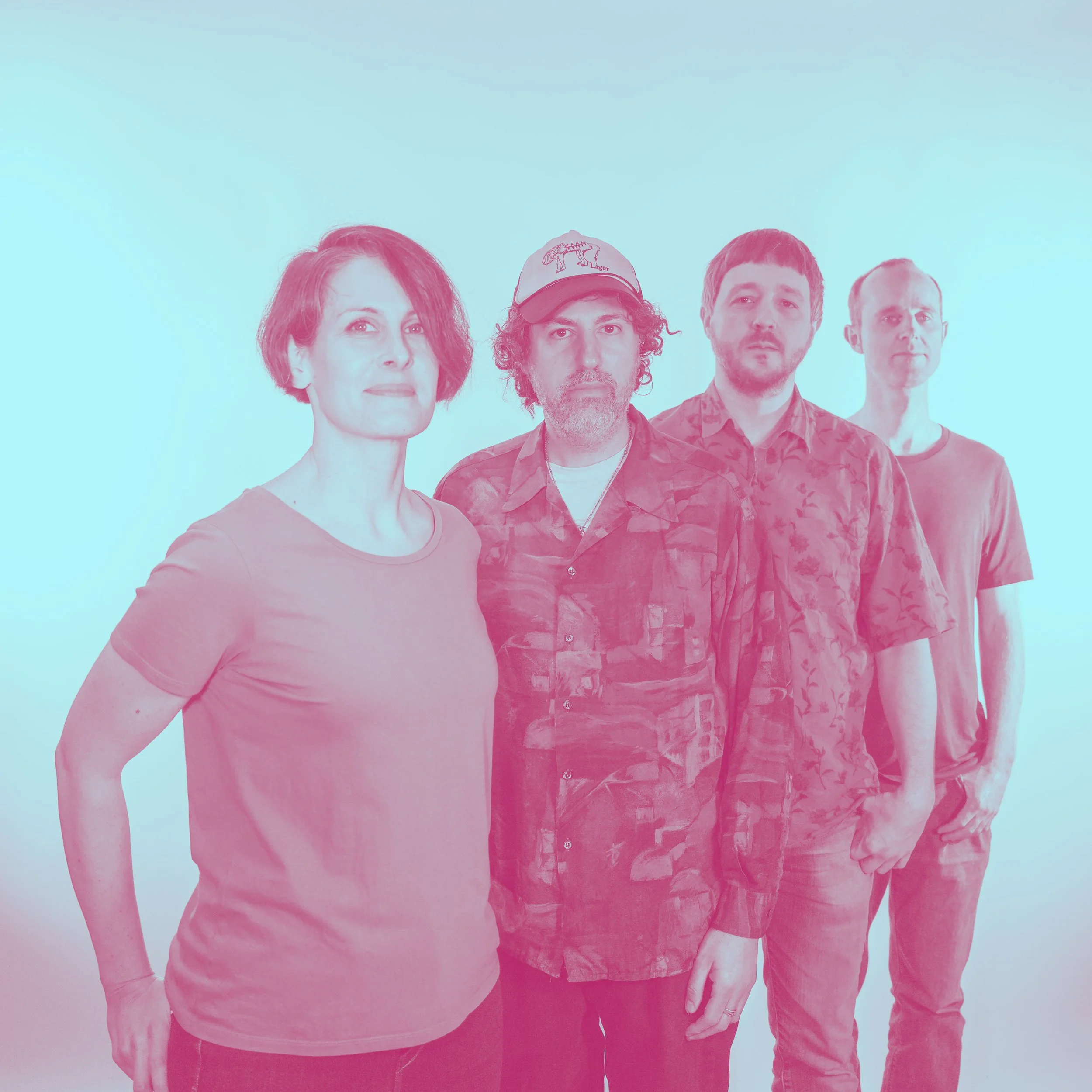 A group of four people standing in a line against a plain background.